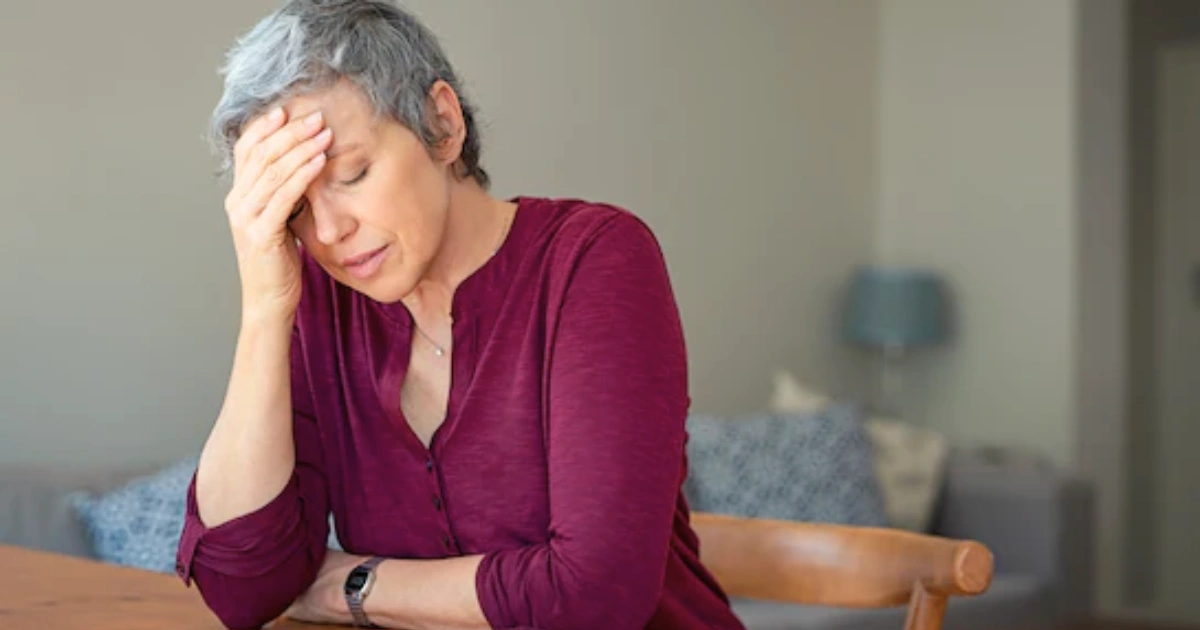 A thoughtful woman in her 40s, representing the journey of understanding perimenopause symptoms and seeking guidance.