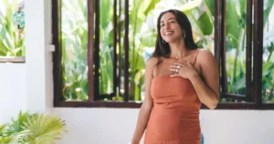Confident woman smiling, symbolizing the positive management of perimenopause and weight gain with support from GlamFit in Goa.